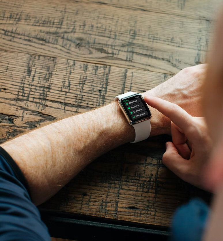 man using apple watch on his wrist