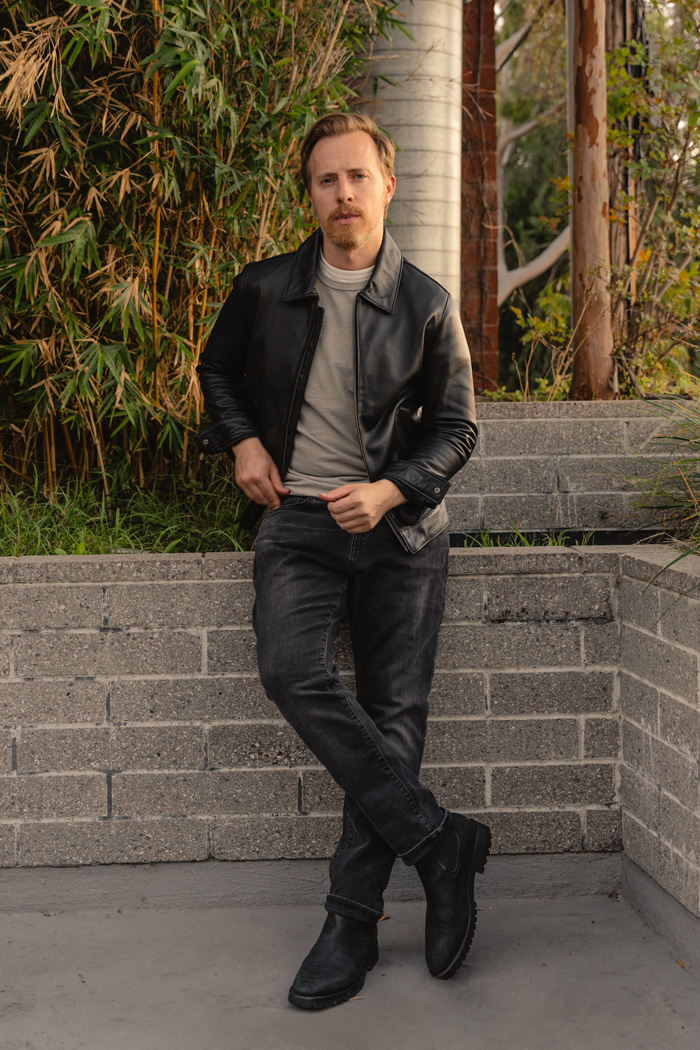 leather jacket and boots outfit with black jacket, gray t-shirt, faded black jeans, and matte black chelsea boots