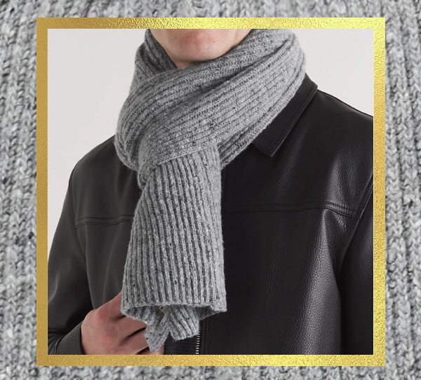 a person wearing a grey scarf and black leather jacket