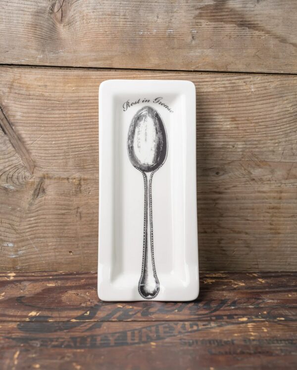 a ceramic spoon rest holder with rest in grease message
