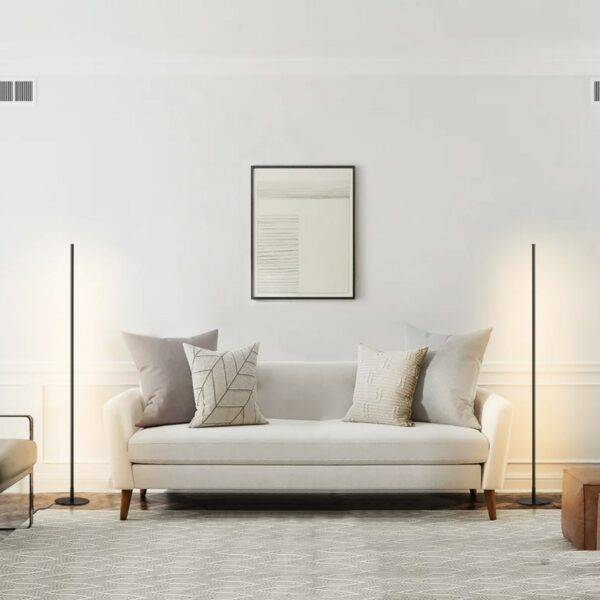 a living room area with a couch and corner floor lamps on each end