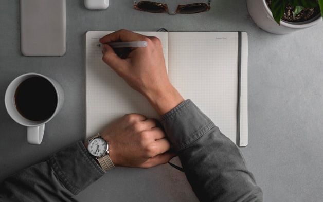 a man journaling in an otebook