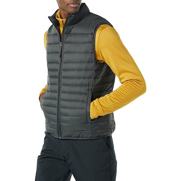 a man wearing a puffer vest over a long sleeve shirt