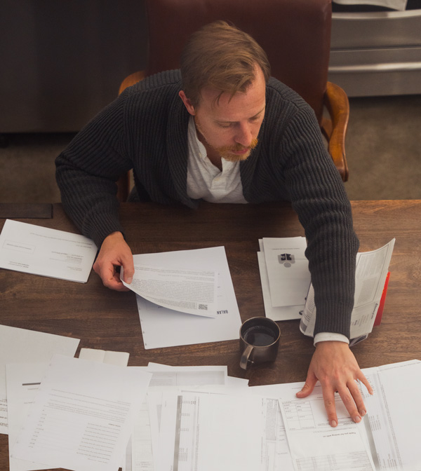 man sitting at table reviewing retirement planning