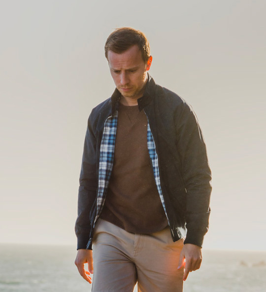 man wearing navy Harrington jacket