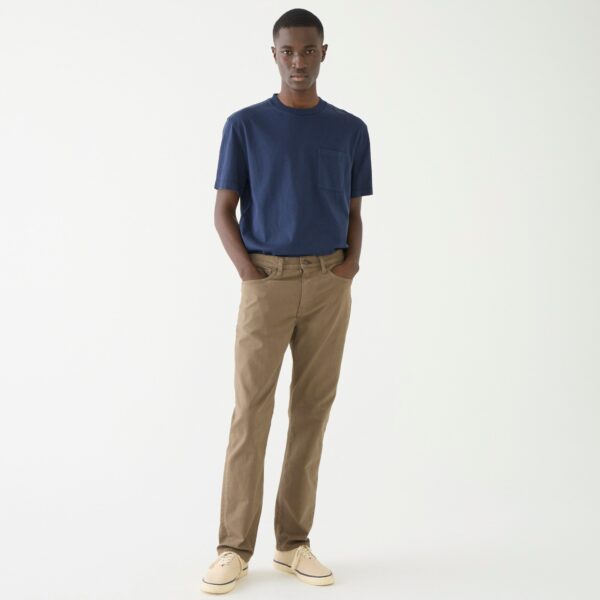 a man wearing slim fit pants and a short sleeve shirt