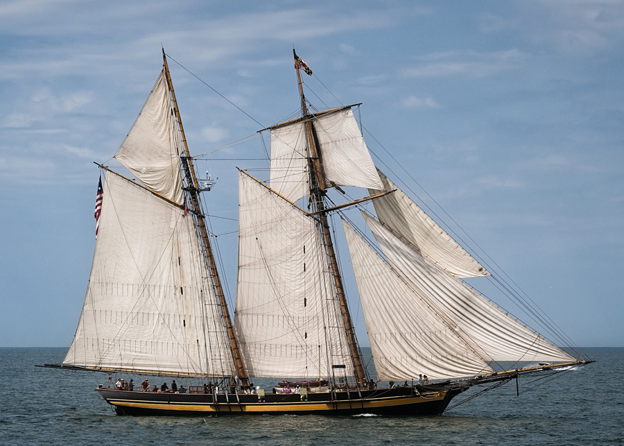 a boat with large canvas sails