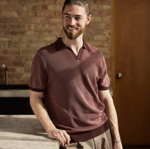 a man wearing a birds eye stitch stye pattern short sleeve polo shirt