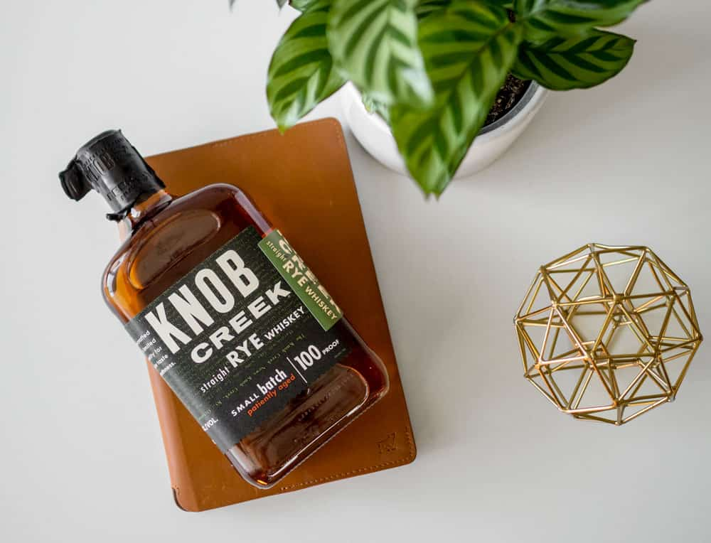 knob creek rye bottle next to plant