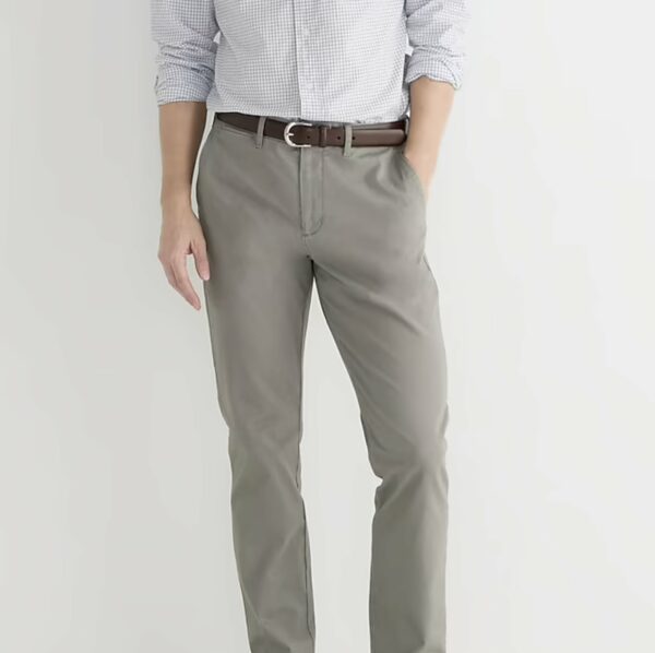 a person wearing chino pants with a brown belt