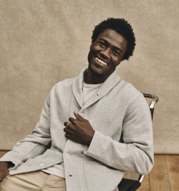 a man wearing a shawl jacket