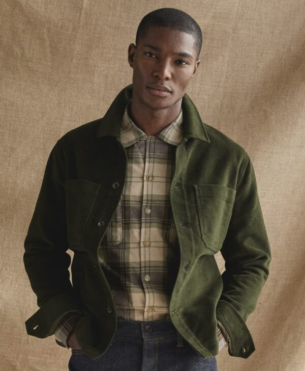 a man wearing a long sleeve moleskin shirt over a button front shirt