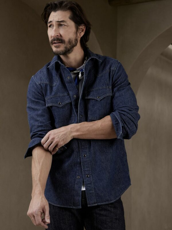 a man wearing a western style denim shirt