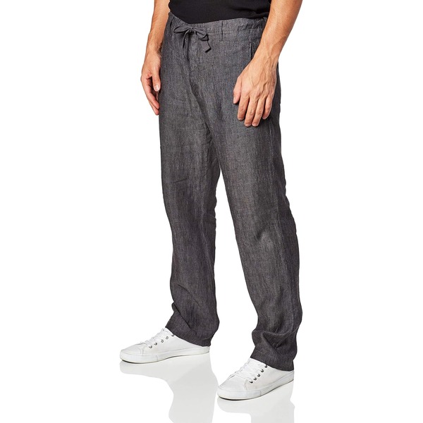 a man wearing linen drawstring pants with casual sneaker shoes