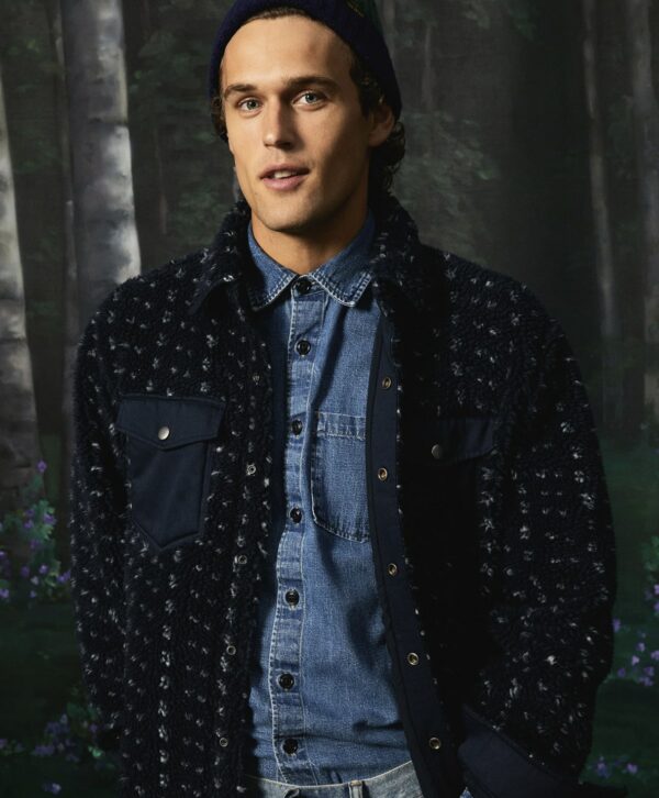 a man wearing a sherpa shirt jacket over a button front shirt