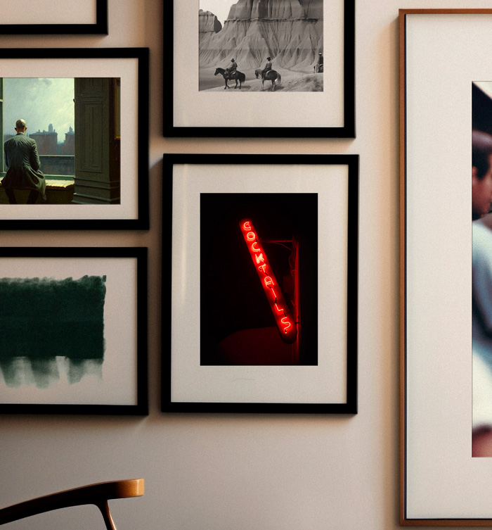 a gallery wall featuring a photo of a neon sign that reads "cocktails"