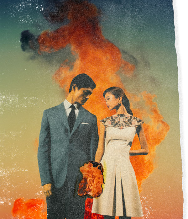 married couple holding hands while a fire burns