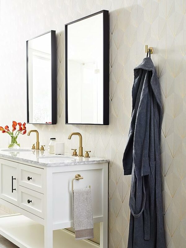 a bathroom area with a robe hanging on a metal hook