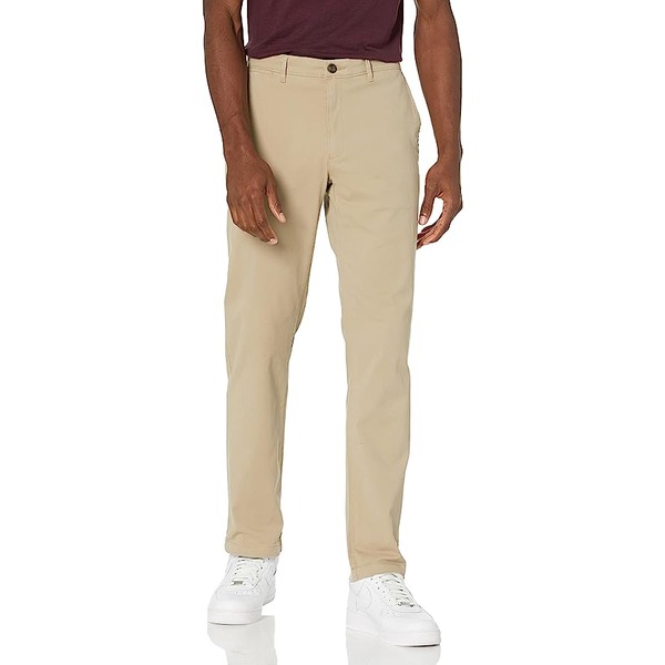 a man wearing slim fit khaki pants with white sneakers