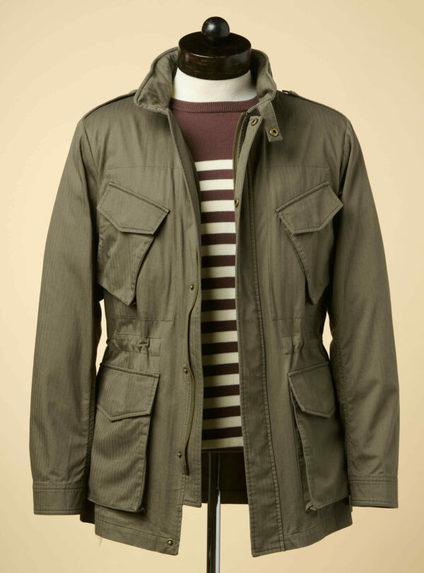 a field jacket over a striped shirt