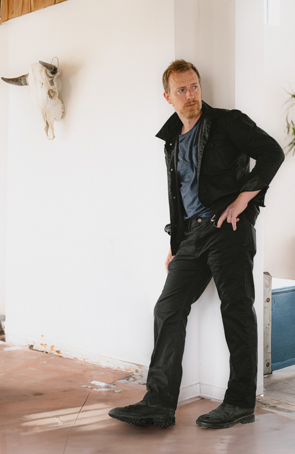 black outfit with black jacket, black jeans, black boots, and blue t-shirt