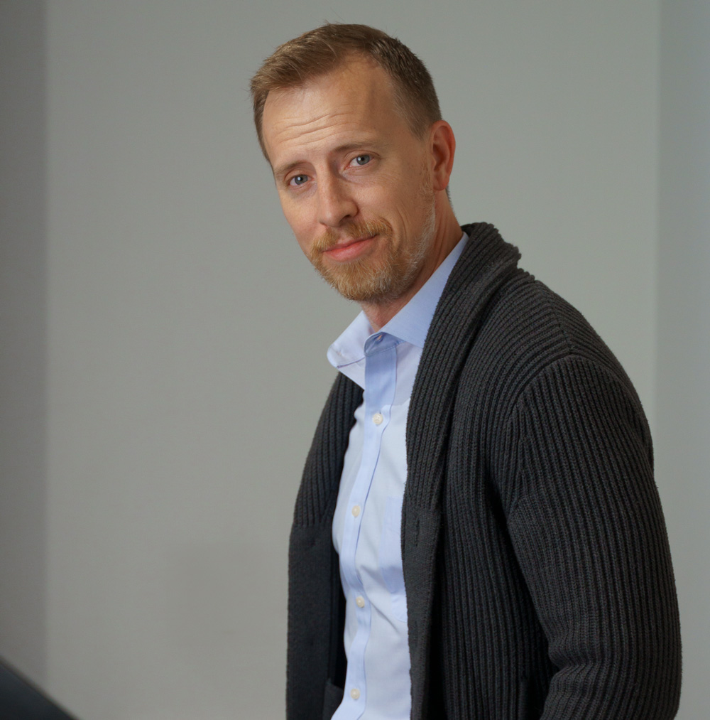 a blue dress shirt under a shawl collar cardigan