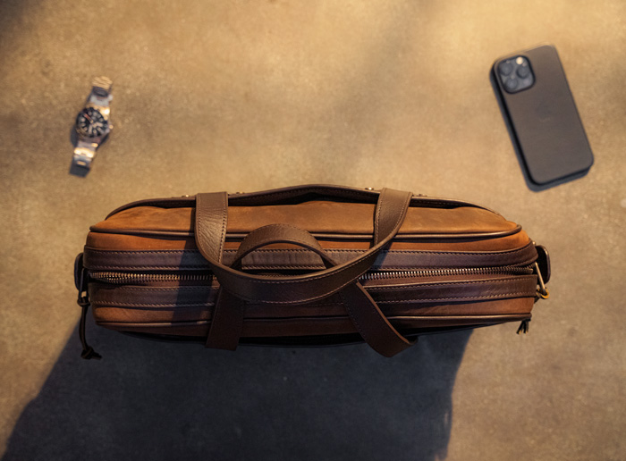 A top down shot of the thursday boot co leather messenger showing a thin profile