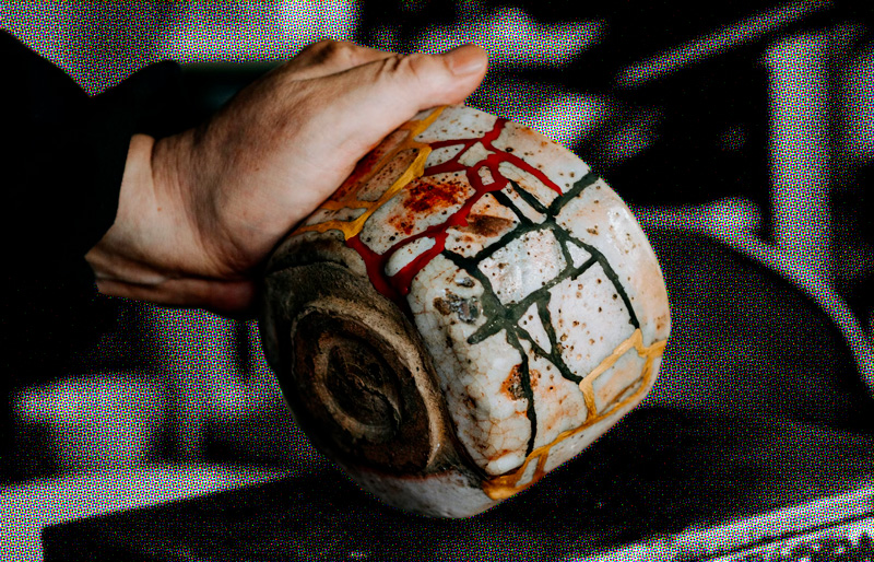 a bowl with colorful lines where it was repaired