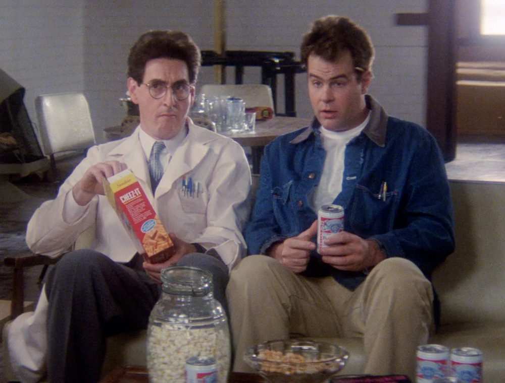 a screenshot from the film ghostbusters showing Ray Stantz wearing a denim chore coat