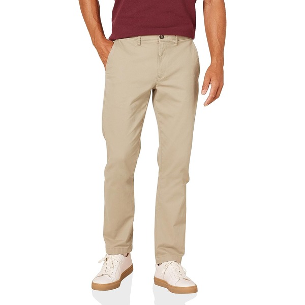 a man wearing slim fit khaki pants with gum sole shoes