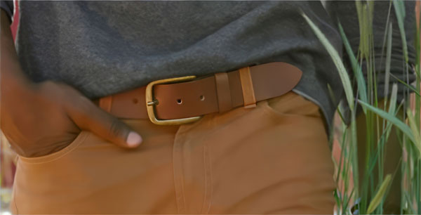 close up of a brown leather belt with a brass buckle