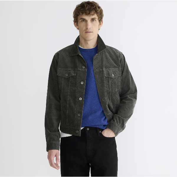 man wearing a corduroy trucker style jacket over a shirt and pants