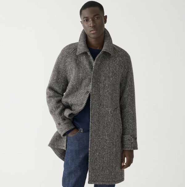 man wearing a herringbone car coat over denim jeans