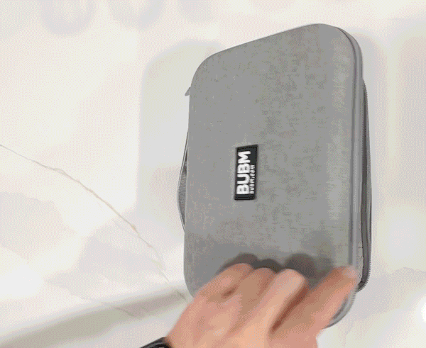 An animated gif opening two sections of a hard-sided dopp kit showcasing how much can be fit into one in an organized way