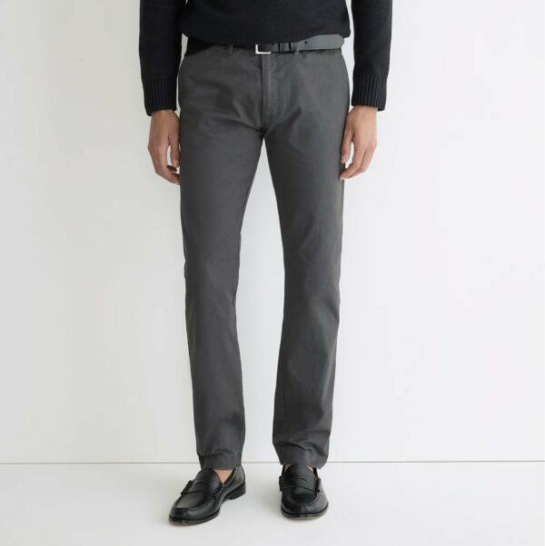 a man wearing slim fit chino pants and loafers