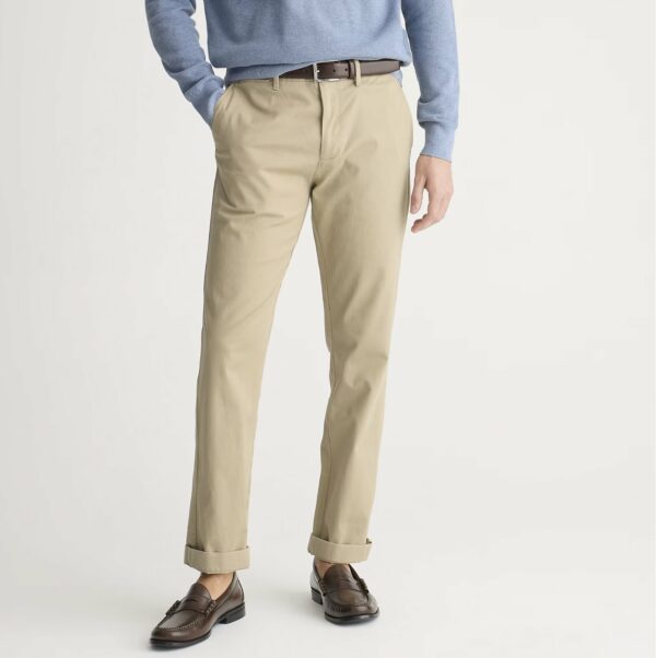 a man wearing straight fit chino pants with a sweater and loafers