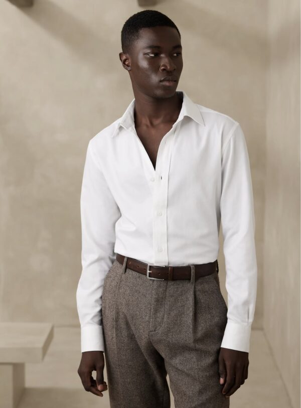 a man wearing a tailored cotton cashmere shirt and trousers