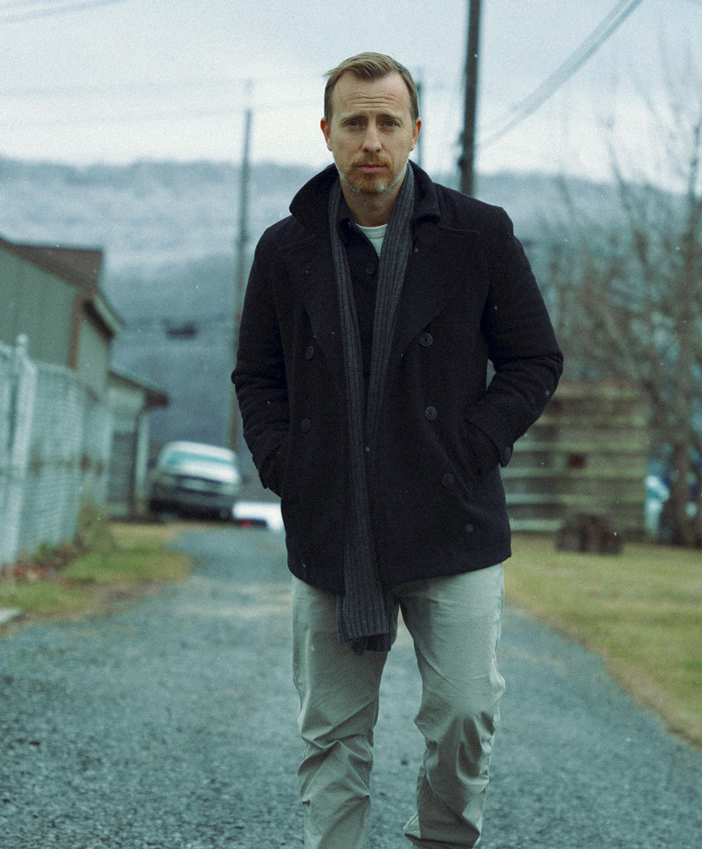 Andrew Snavely wearing a black thigh length pea coat