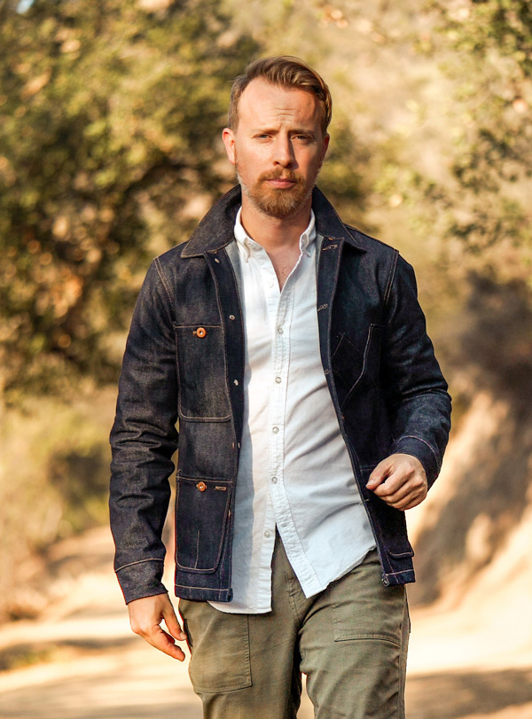 andrew wearing a white oxford shirt under a denim jacket