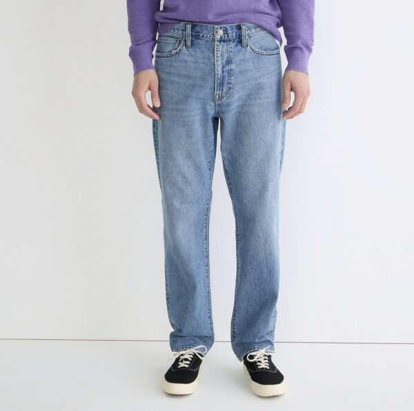 a man wearing denim jeans with casual shoes and a long sleeve shirt