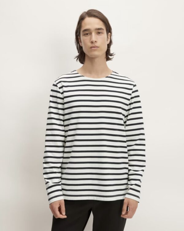 a man wearing a striped long sleeve crew neck shirt