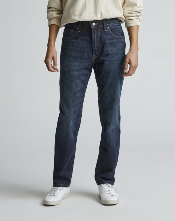 a man wearing straight fit denim jeans and casual sneakers