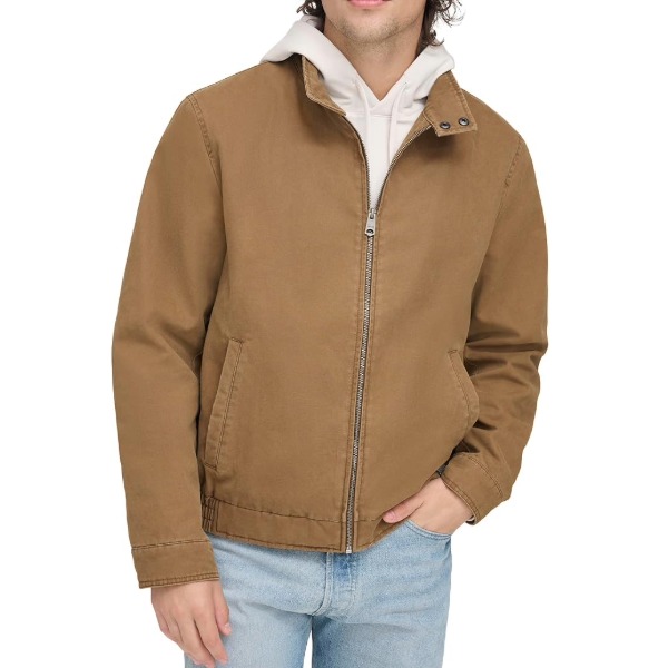 man wearing a cotton harrington style jacket over a hoodie and denim jeans