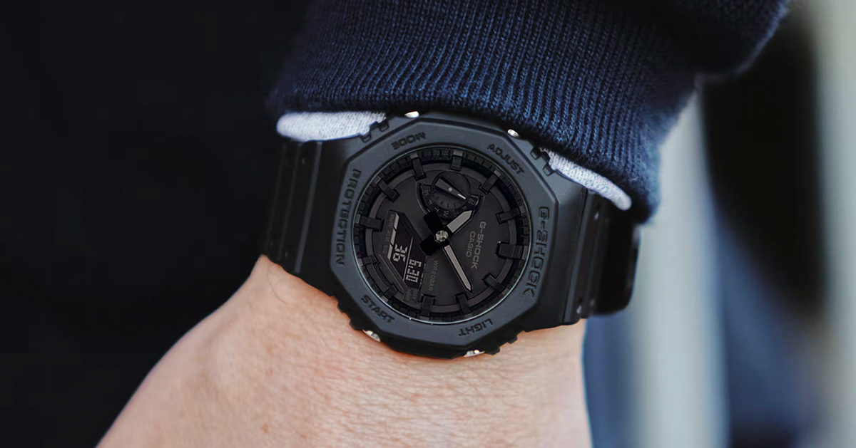 g-shock black on black watch on man's wrist