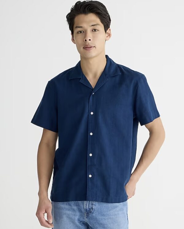 a man wearing a short sleeve button front camp collar shirt