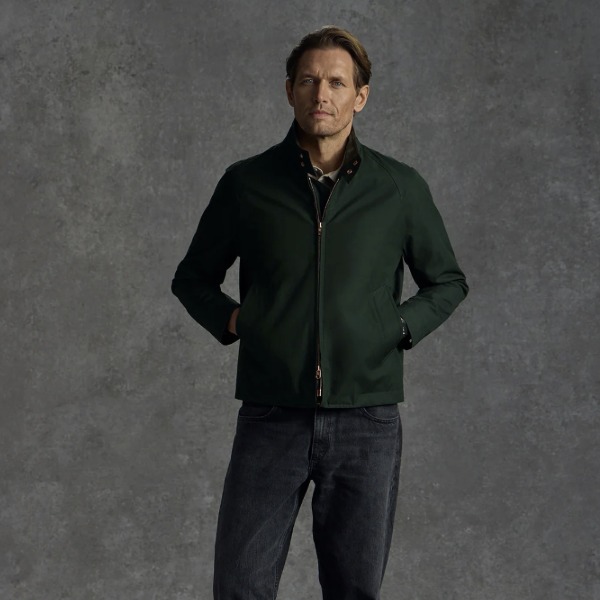 man wearing a harrington style jacket over denim jeans