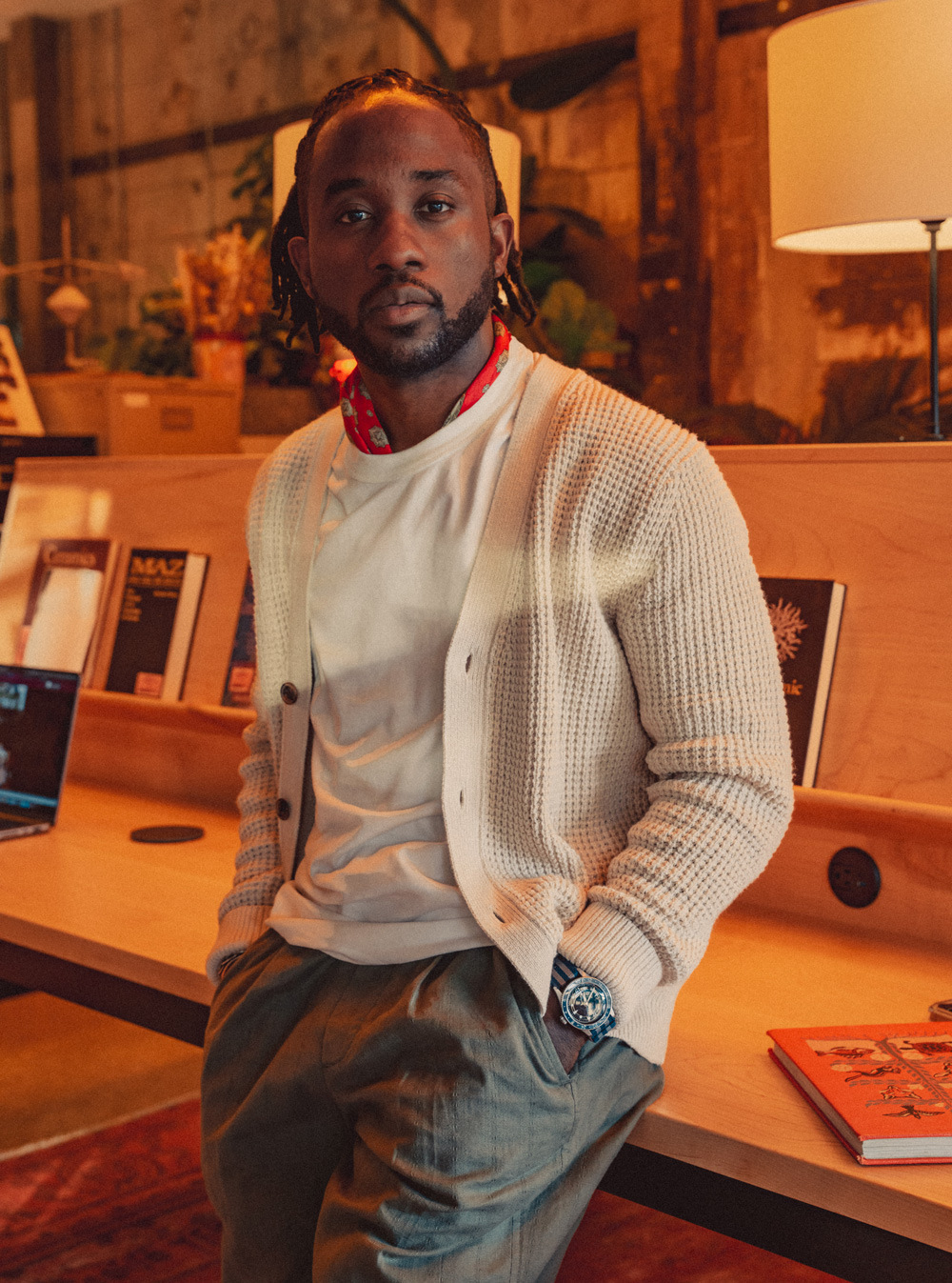 Daniel wearing a white t-shirt, cardigan, and linen drawstring pants