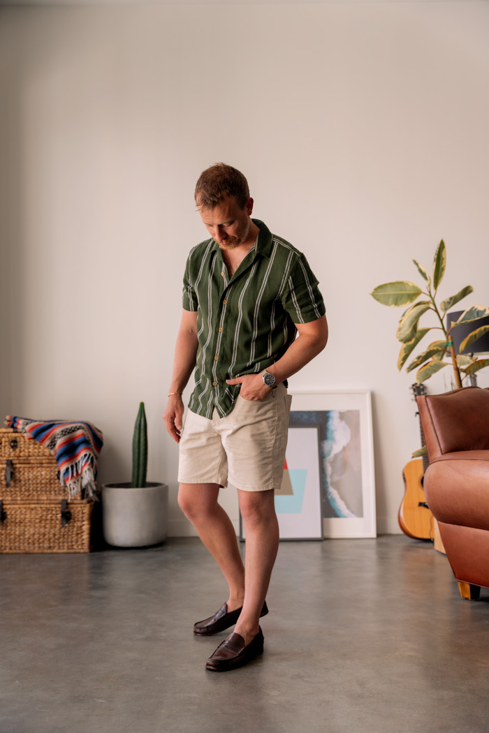 Andrew wearing a green striped buttotn up shirt