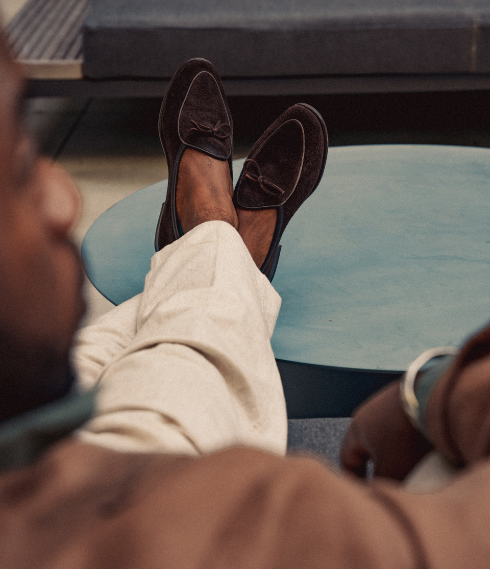 over the shoulder shot of Daniel's brown suede loafers