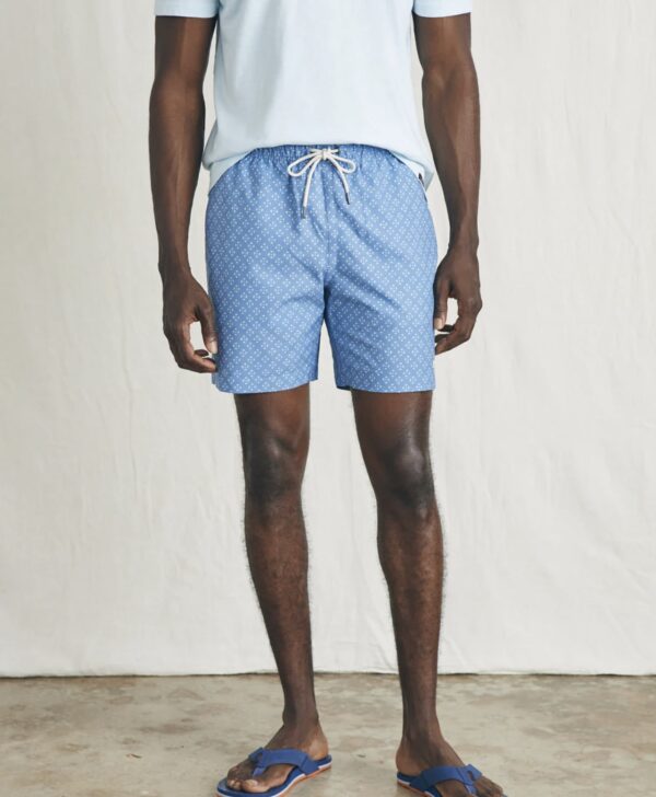 a man wearing swim trunks with drawstring waist and white and blue print pattern